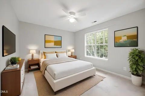 an empty room with chandelier fan and windows