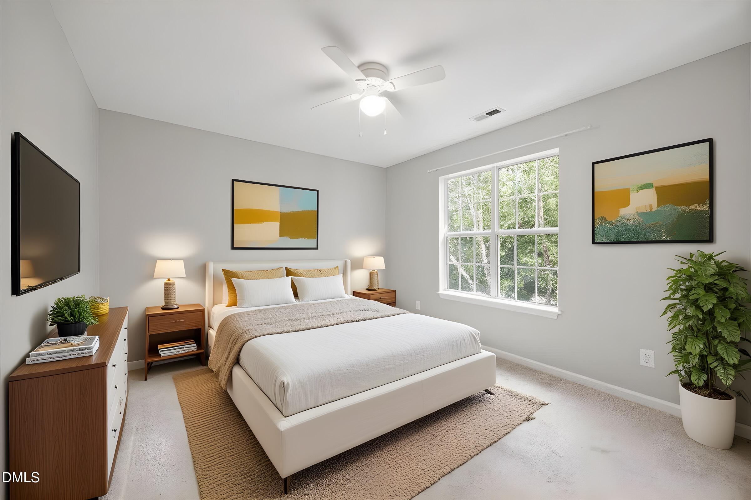 4329 Pine Springs Court Raleigh, NC 27613 - Photo 24 of 35 a bedroom with a large bed and a flat screen tv
