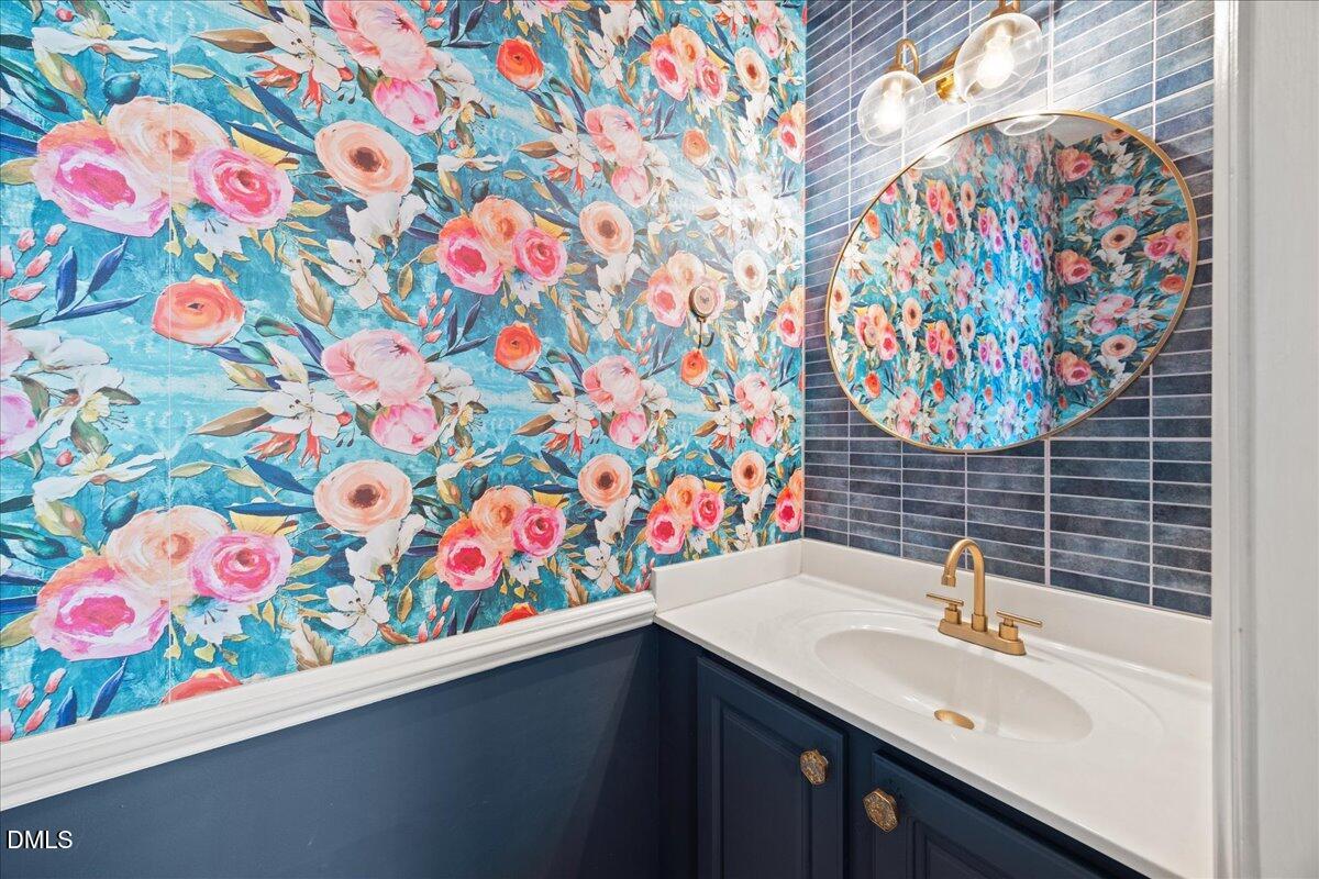 4329 Pine Springs Court Raleigh, NC 27613 - Photo 8 of 35 a bathroom with a sink a vanity and a shower curtain