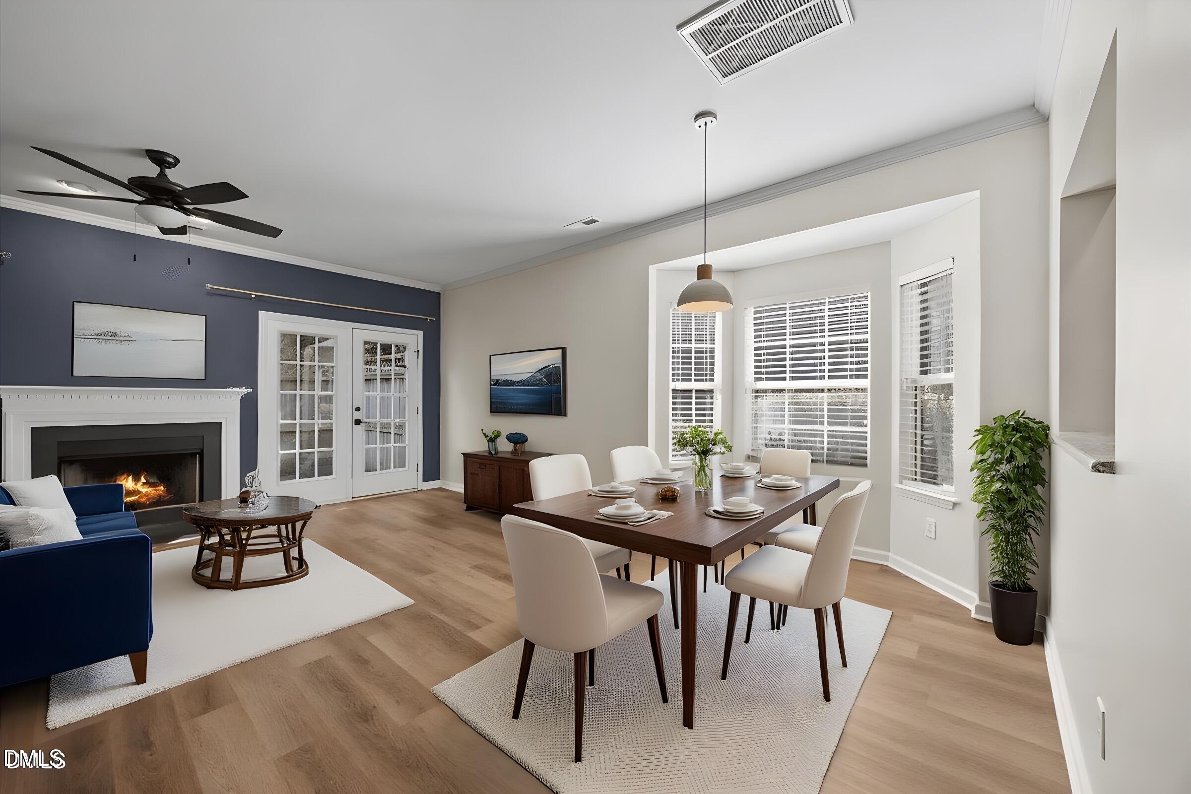 4329 Pine Springs Court Raleigh, NC 27613 - Photo 9 of 35 a living room with furniture a fireplace and a table