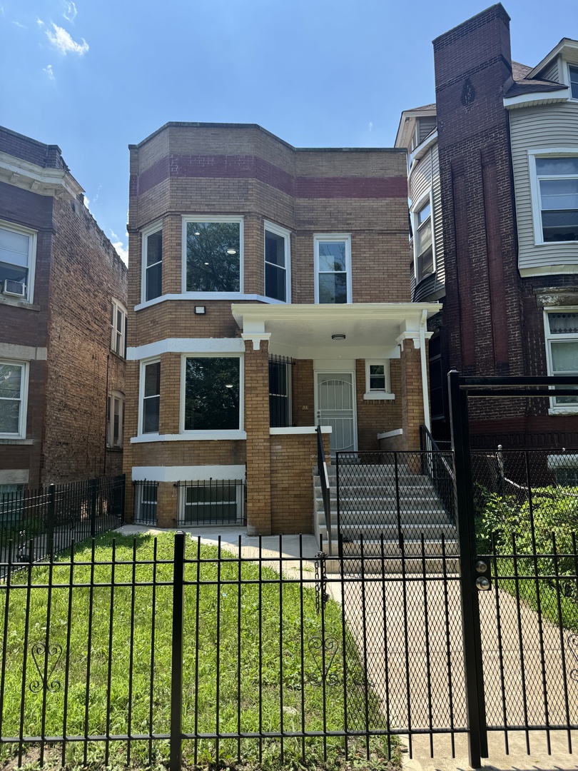 7204 South Union Avenue Chicago, IL 60621 - Photo 1 of 12 a front view of a house with a garden and plants