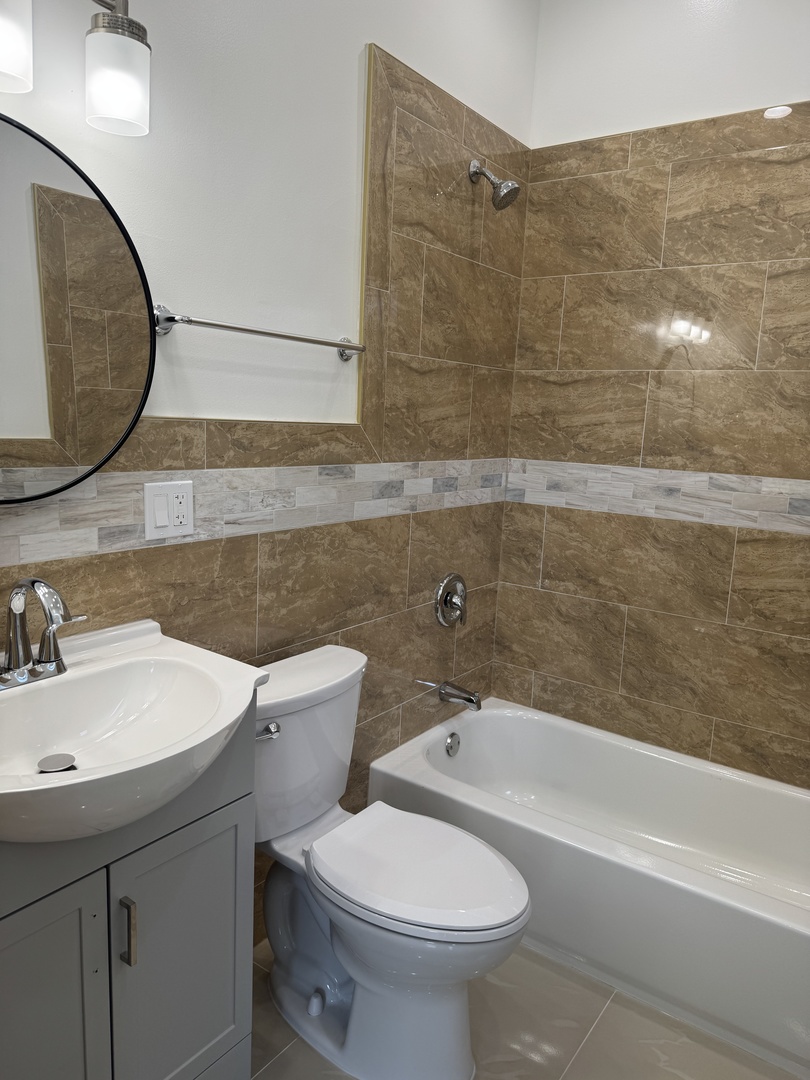 7204 South Union Avenue Chicago, IL 60621 - Photo 11 of 12 a bathroom with a sink and mirror