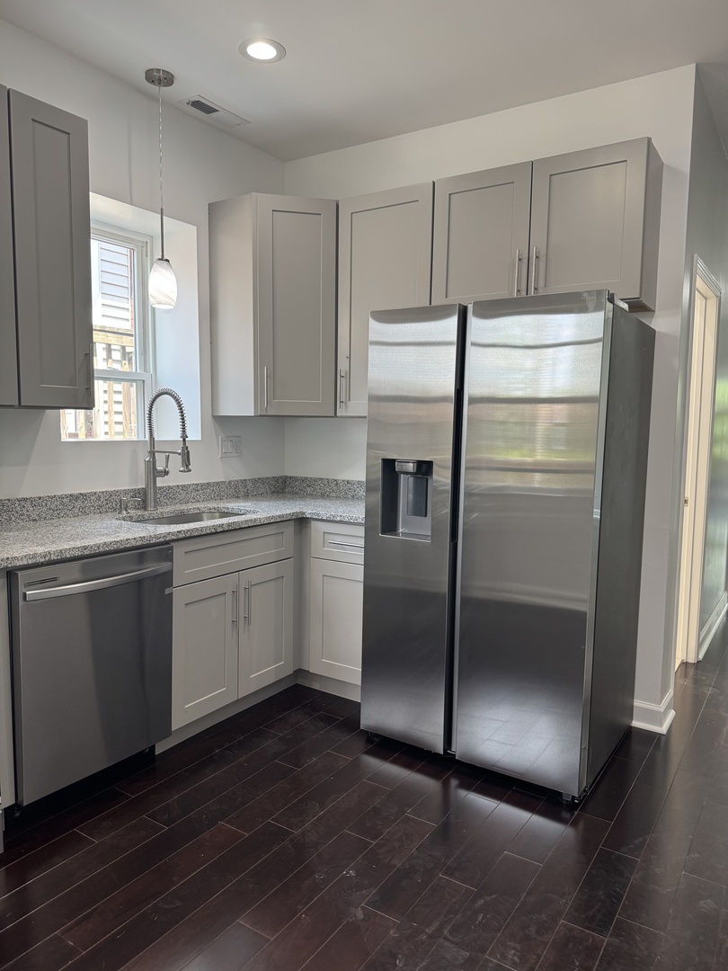 7204 South Union Avenue Chicago, IL 60621 - Photo 6 of 12 a kitchen with a refrigerator sink and cabinets