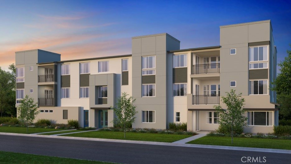 a front view of a residential apartment building with a yard