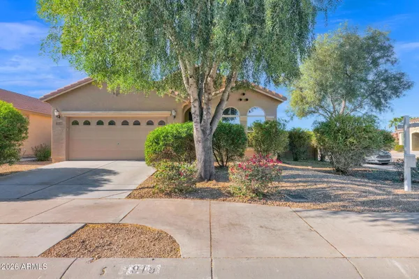 a view of a house with a yard and tree s