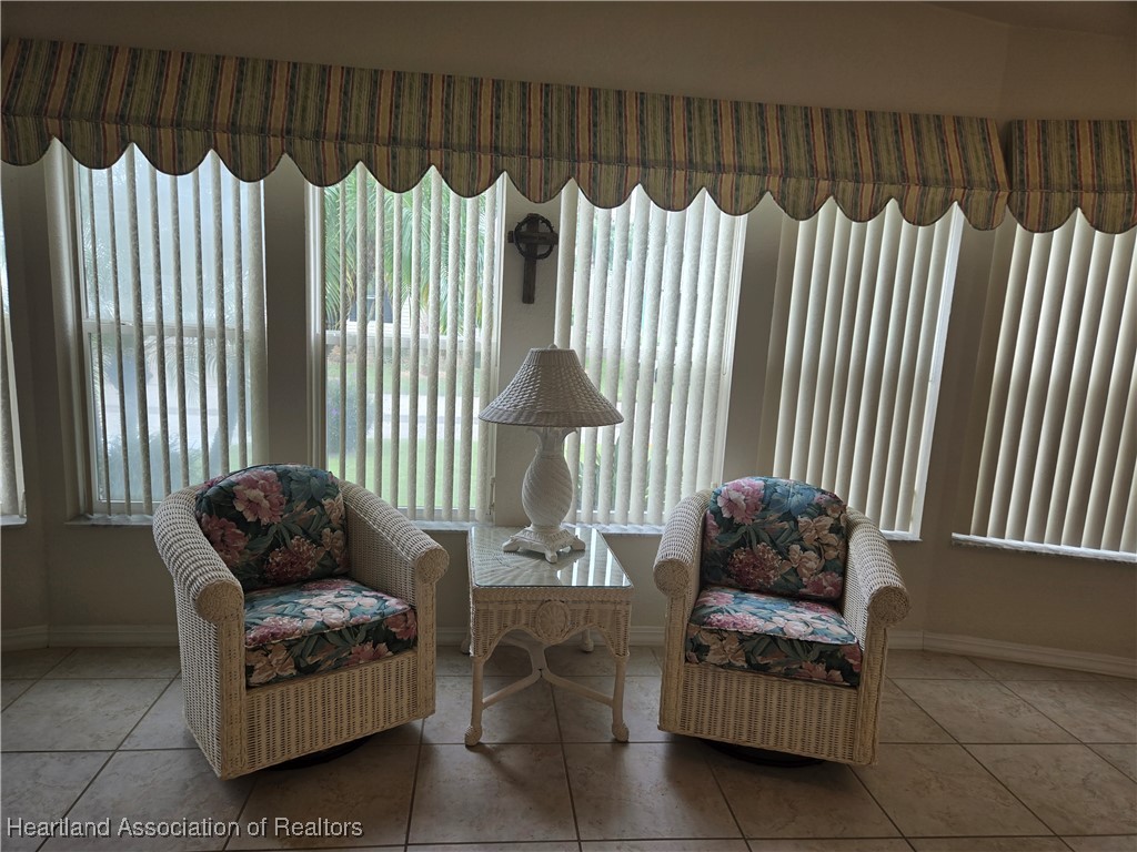 3312 Beartooth Pass Sebring, FL 33872 - Photo 10 of 39 a living room with furniture rug and a lamp