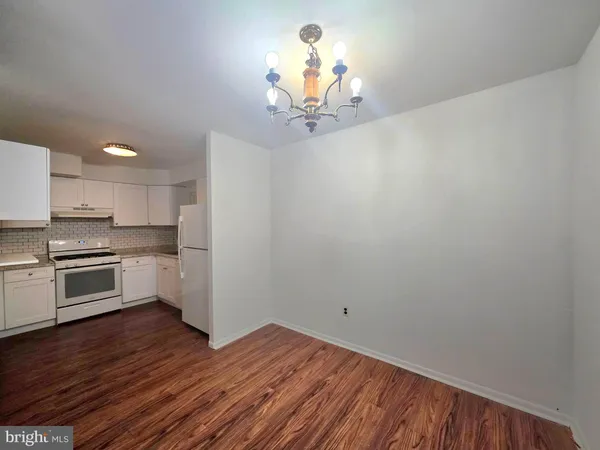 a view of a kitchen with a dishwasher cabinets and wooden floor