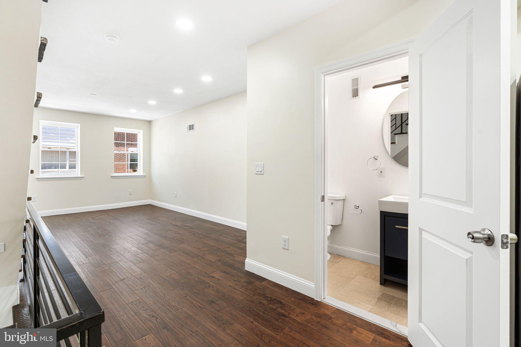 1535 South Mole Street Philadelphia, PA 19146 - Photo 11 of 28 an empty room with wooden floor and windows