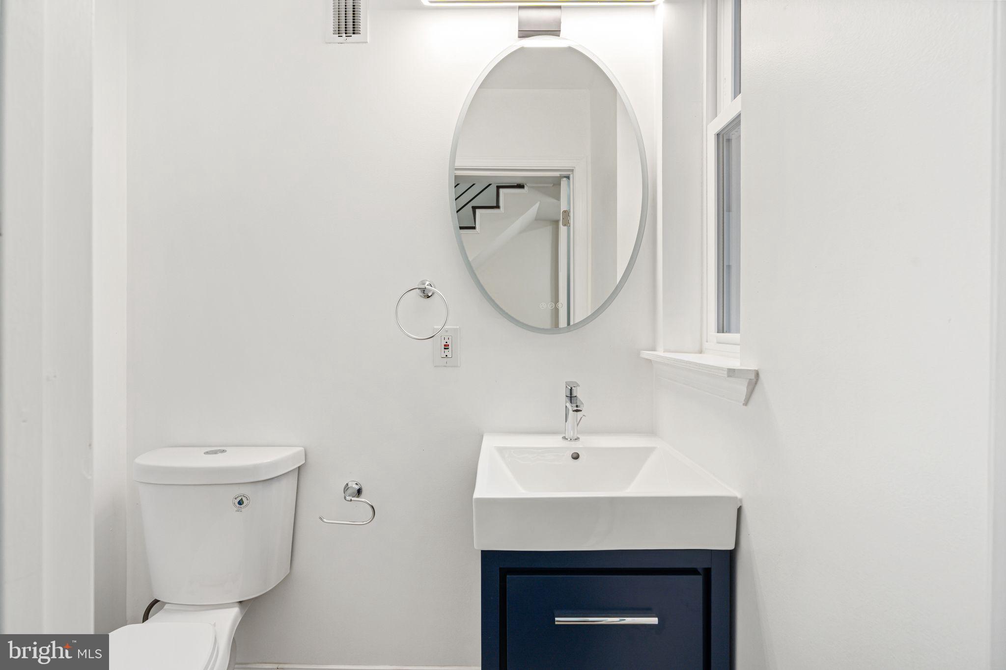 1535 South Mole Street Philadelphia, PA 19146 - Photo 12 of 28 a bathroom with a sink a toilet and a mirror