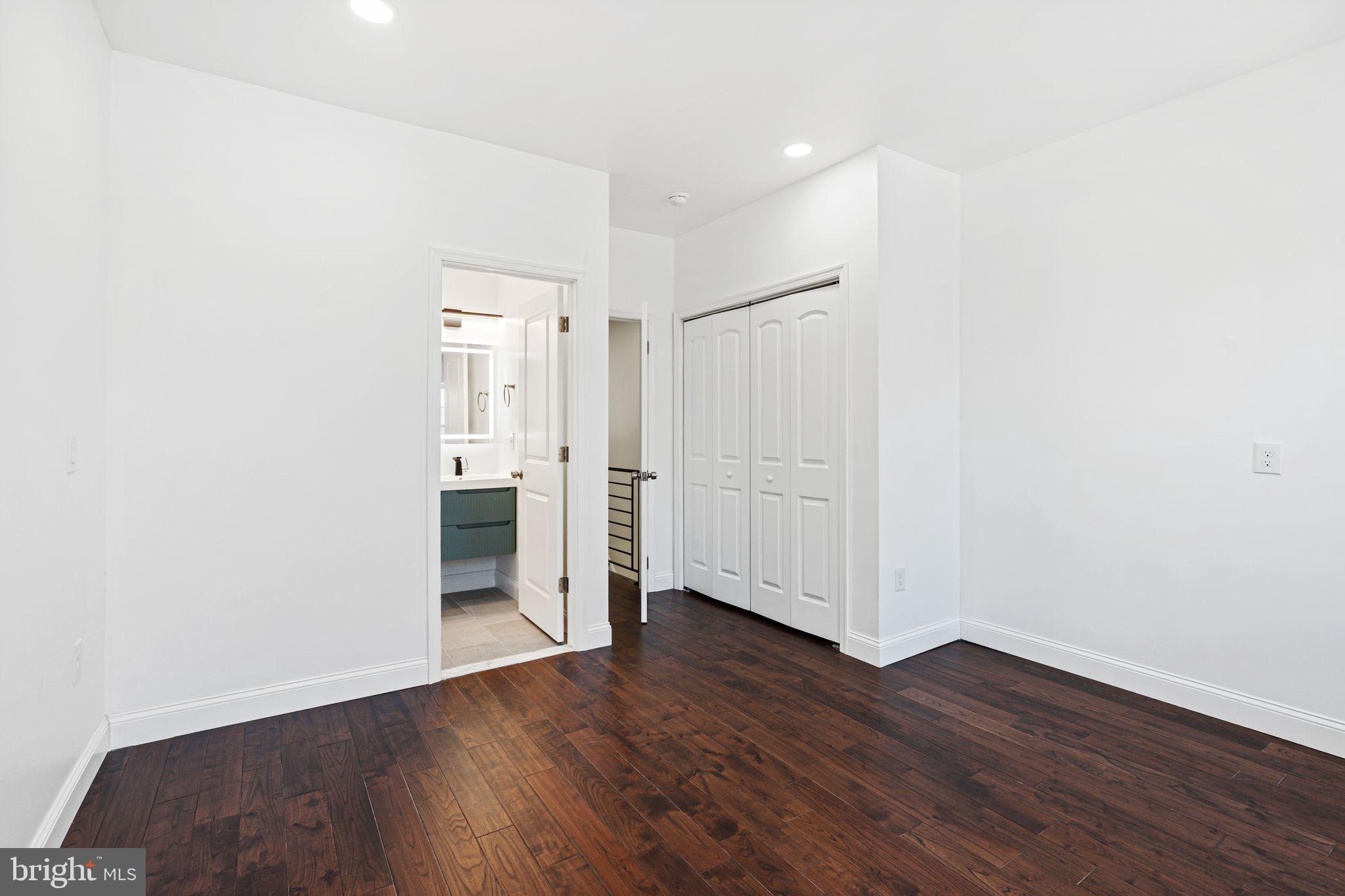 1535 South Mole Street Philadelphia, PA 19146 - Photo 20 of 28 an empty room with wooden floor & windows and bathroom