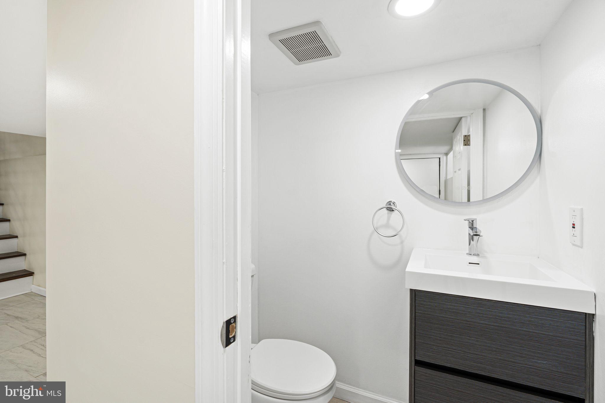 1535 South Mole Street Philadelphia, PA 19146 - Photo 26 of 28 a bathroom with a sink mirror and toilet
