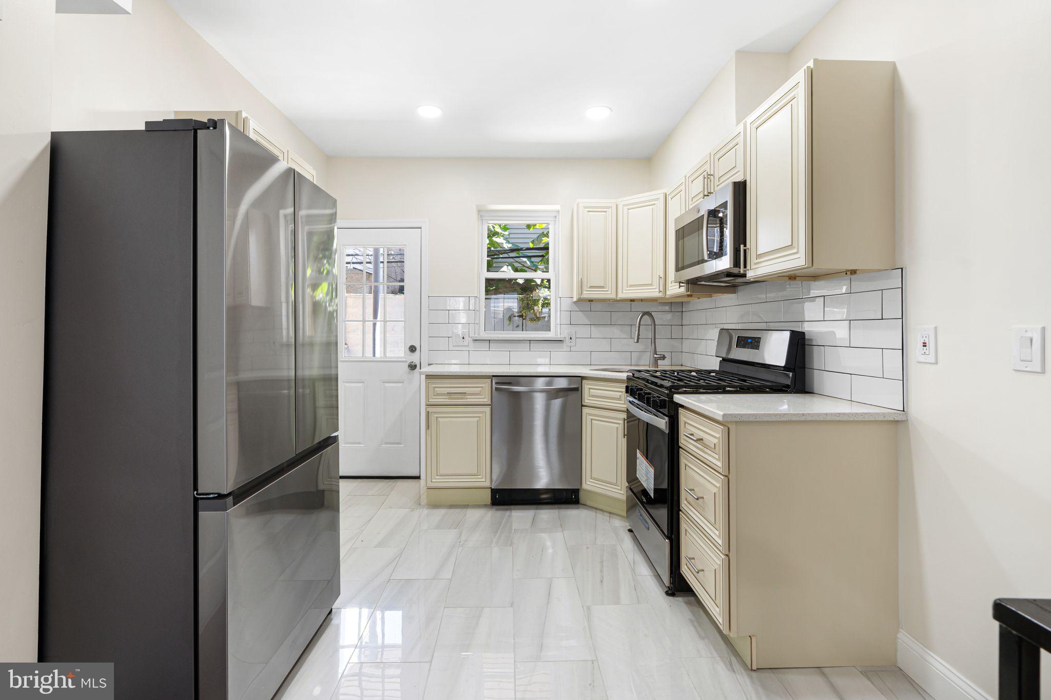1535 South Mole Street Philadelphia, PA 19146 - Photo 5 of 28 a kitchen with stainless steel appliances granite countertop a refrigerator sink and stove