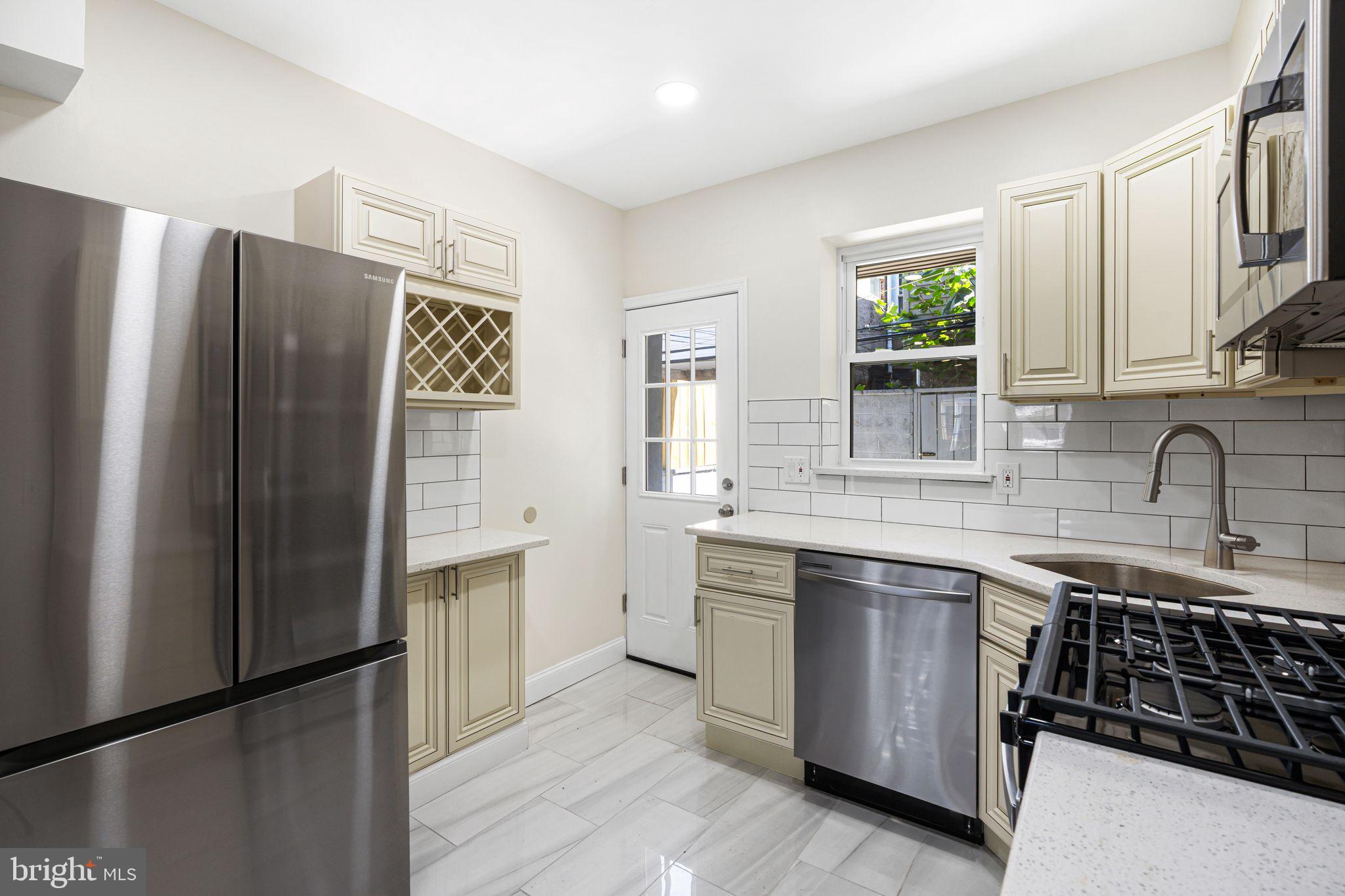 1535 South Mole Street Philadelphia, PA 19146 - Photo 7 of 28 a kitchen with stainless steel appliances granite countertop a refrigerator and a sink