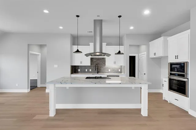 a view of kitchen with stainless steel appliances kitchen island sink refrigerator and stove