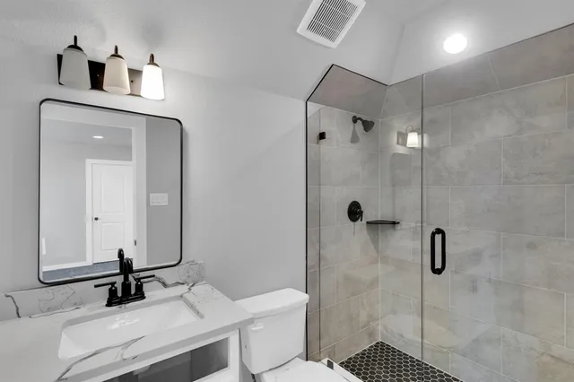 a en suite bathroom with a double vanity sink a mirror and a shower