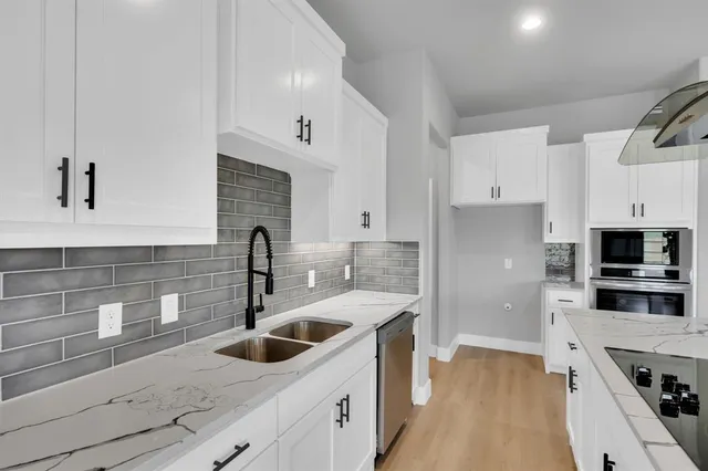 a kitchen with a sink and a refrigerator