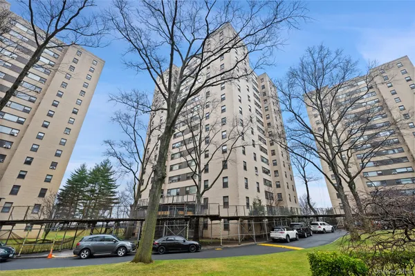 a front view of a building with trees