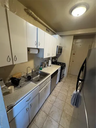 a kitchen with a sink appliances and cabinets
