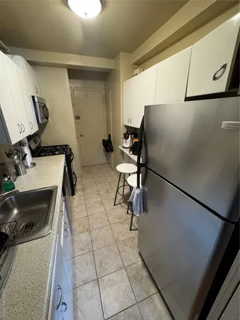 a kitchen with a sink a stove and a refrigerator