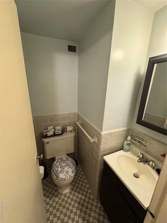 a bathroom with a sink toilet and vanity