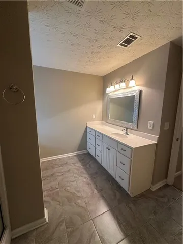 a bathroom with a double vanity sink and mirror