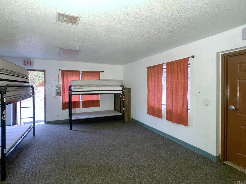 24352 Featherstone Canyon Road Lakeside, CA 92040 - Photo 14 of 68 a bedroom with furniture and window