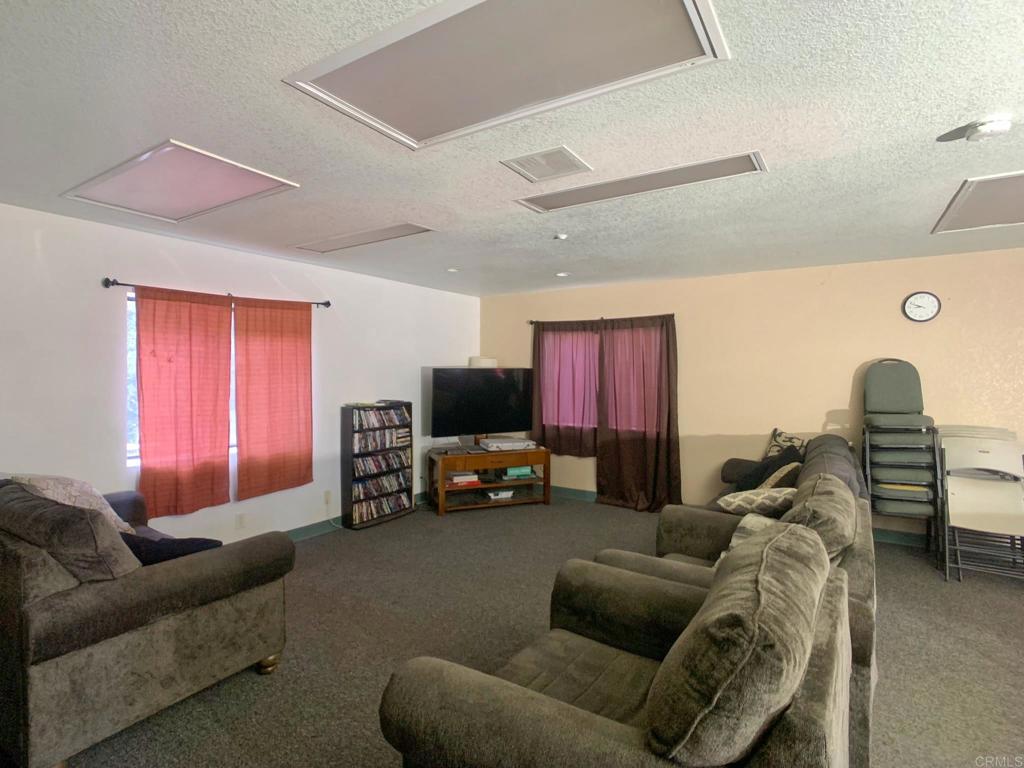 24352 Featherstone Canyon Road Lakeside, CA 92040 - Photo 27 of 68 a living room with furniture and a flat screen tv