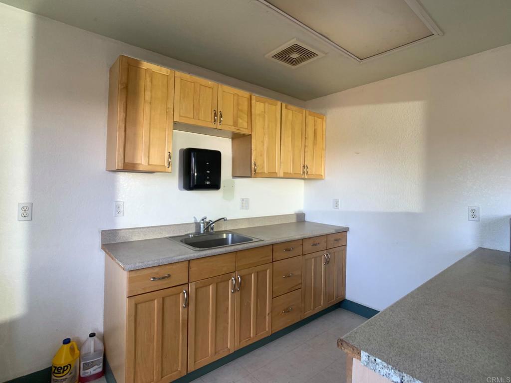 24352 Featherstone Canyon Road Lakeside, CA 92040 - Photo 30 of 72 a kitchen with a sink stove and microwave