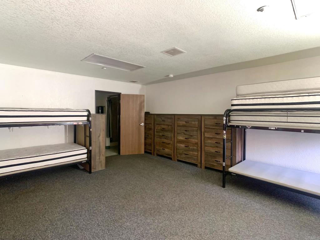 24352 Featherstone Canyon Road Lakeside, CA 92040 - Photo 32 of 72 a view of an empty room with a fireplace