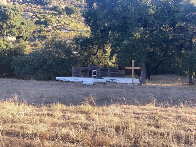 a aerial view of a house next to a yard with large tree