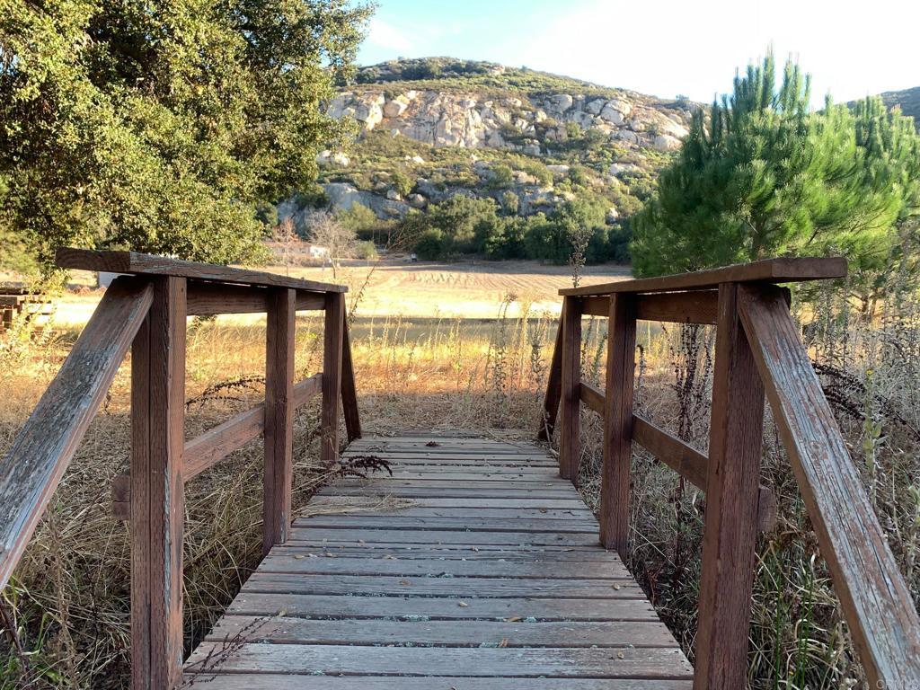 24352 Featherstone Canyon Road Lakeside, CA 92040 - Photo 50 of 72 a view of a pathway with wooden floor next to a building