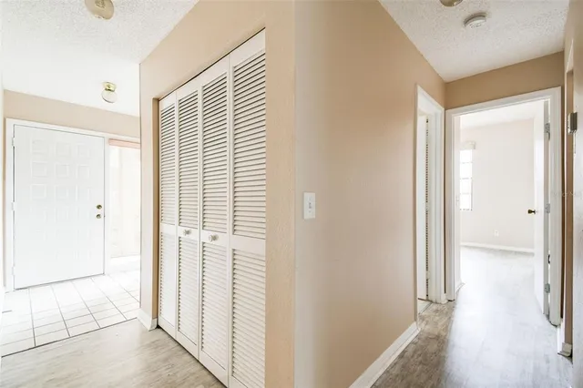 a view of a livingroom with wooden floor and windows