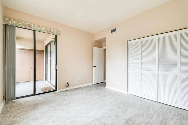 an empty room with sliding door and mirror