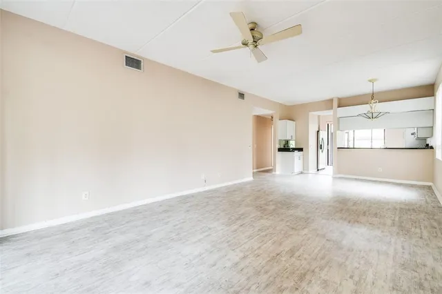 a view of large kitchen with a sink and a refrigerator