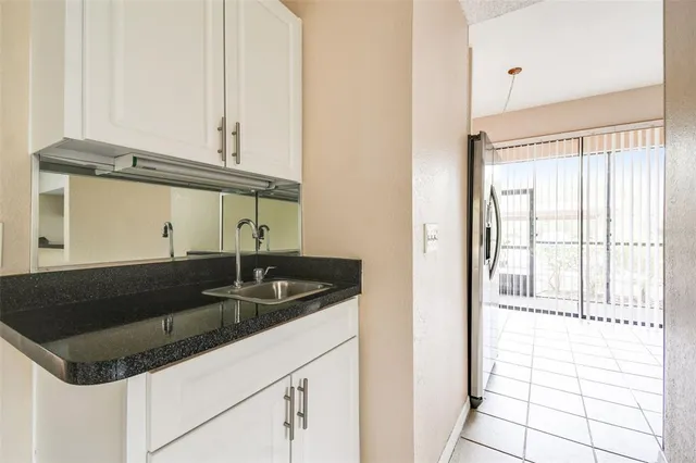 a kitchen with granite countertop a sink and a window