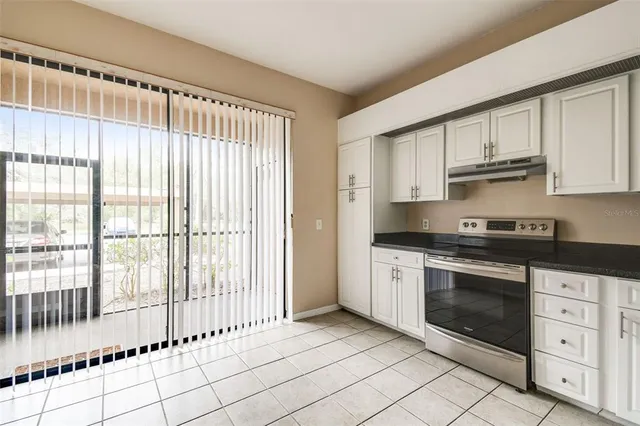 a kitchen with stainless steel appliances a stove sink and cabinets