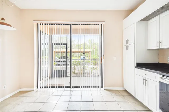 a view of a kitchen with white cabinets