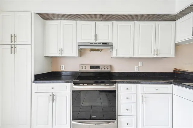 a stove top oven sitting inside of a kitchen