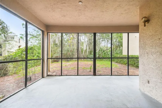 a view of an empty room with large windows