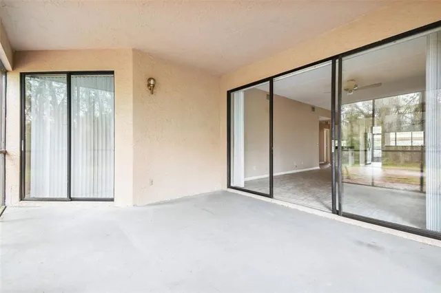 a view of an empty room with glass door