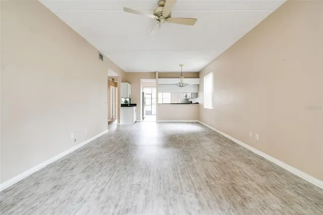 a view of a kitchen with a sink and a refrigerator