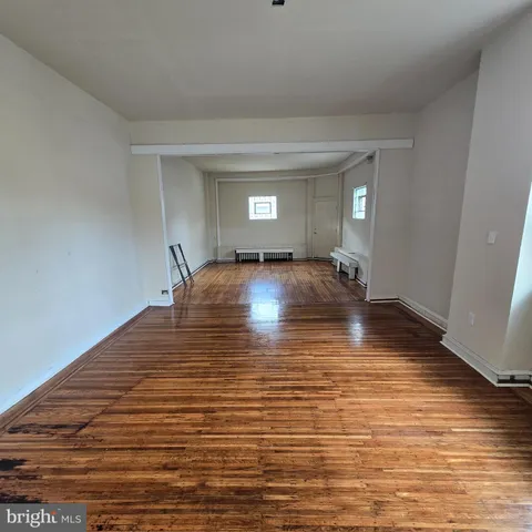 a view of a room with wooden floor