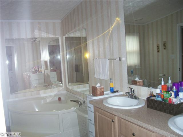 1740 Traphill Union Road Traphill, NC 28685 - Photo 8 of 14 Master Bath/Spa. Romantic Garden Tub, Double Sinks, Seperate shower, nice cabnetry and mirrors.
