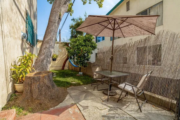 a patio with a patio table and chairs