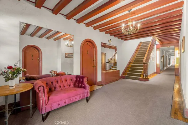 a living room with furniture and stairs