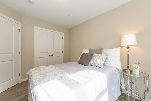 a bedroom with a bed and a lamp