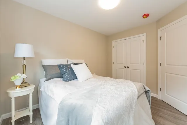 a bedroom with a bed and a lamp