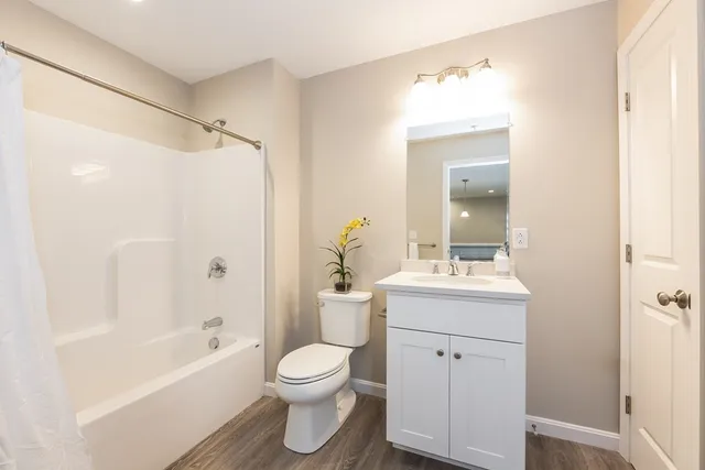 a bathroom with a sink toilet and shower
