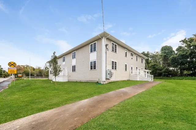 a view of a house with a yard