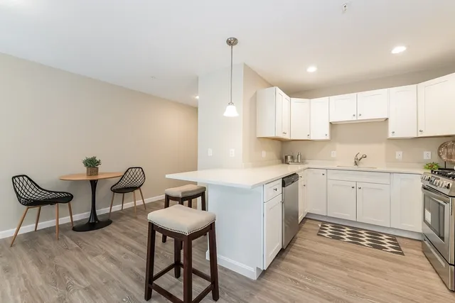 a kitchen with a table chairs and a sink